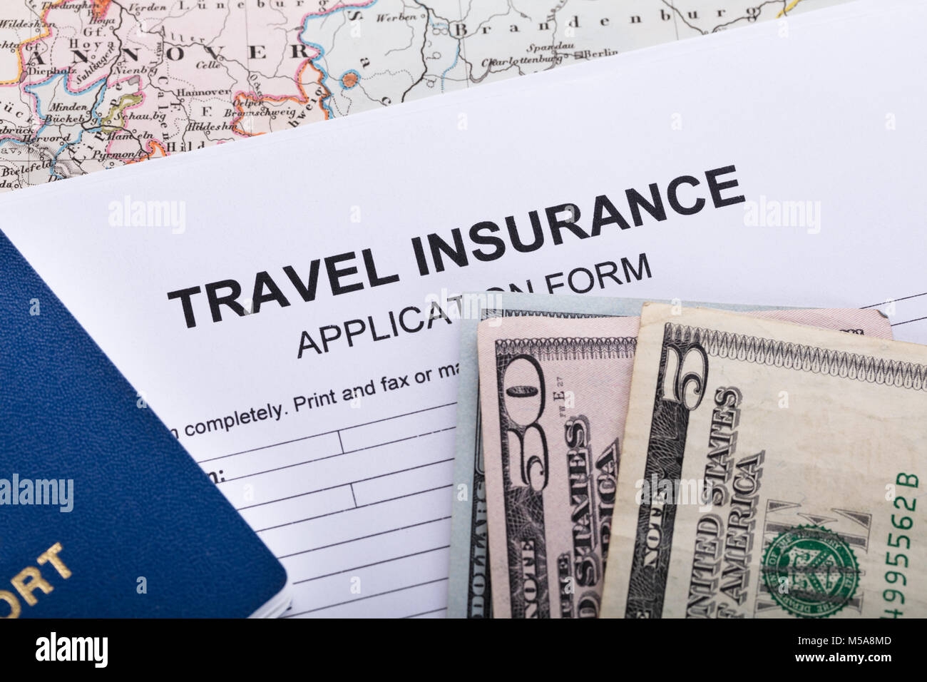 High Angle View Of Currency Notes And Passport On Insurance Application Form Stock Photo Alamy